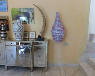 Pair of mirrored cabinets, bric-a-brac, framed African animal photographs, lucite pedestal, rolled paper vase