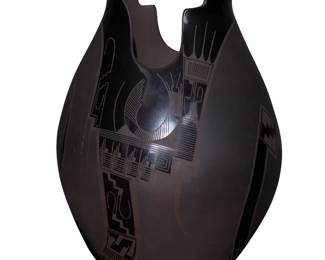 134
Lydia Quezada Celado (b. 20th century)
A Mata Ortiz blackware pottery jar, late 20th/early 21st century; Chihuahua, Mexico
Incised to underside: Lydia Quezada
With a stylized kiva step-form rim, featuring black stepped and geometric motifs on a black buff ground
14.5" H x 9.5" Dia.
Estimate: $600 - $900
