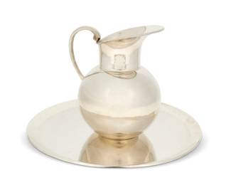286
Mid-20th century
A Mexican sterling silver pitcher and tray
Pitcher marked: JLR / Sterling / Made in Mexico / 925; tray marked: M.R.M. Hecho en Mexico D.F. / 925 / sterling 925 / [Eagle 145]
Comprising a Juventino Lopez Reyes water pitcher and a circular tray from an unknown maker
2 pieces
Pitcher: 7.75" H x 6.5" W x 6" D; Tray: 12.5" Dia.
46.9 oz. troy approximately
Estimate: $1,000 - $1,500