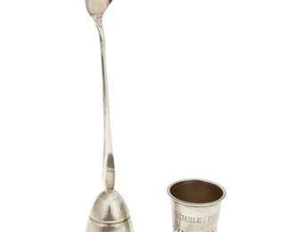 303
Mid-20th century
Two Mexican silver cocktail items
Jigger marked: Sanborns [owl logo] / Mexico / Sterling / 925 / 385 [design no.] / [Eagle 1] / R; Thimble marked: California / Taxco / Sterling / Plata / 925 / [Eagle 3]
Comprising a sterling silver Sanborns flared jigger with integral mixing spoon, together with a sterling silver thimble-shaped jigger with engraved phrase: "Thimble Full"
2 pieces
Larger: 9" H x 2" Dia.; Smaller: 2" H x 1.75" Dia.
2.925 oz. troy approximately
Estimate: $100 - $200