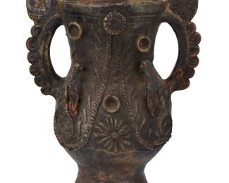 87
Early 20th century; Totonicapan, Guatemala
A Guatemalan pottery urn
Possibly sacramental, the footed vessel with opposed sculptural lug handle surmounted by pinecone finials, the front of the body featuring two eagle figures in relief
19" H x 14.5" W x 11" D
Estimate: $200 - $400