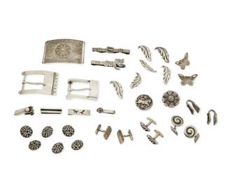 369
A group of Mexican silver dress accessories
Mid-20th century
Most variously marked for maker, for country, and for sterling; further variously marked: [Design number] / [Eagle 9] / [Eagle 1] / [Eagle 3]
Eighteen works in silver and mixed metal, some with set stones including obsidian and hardstone mosaic, by makers including Margot de Taxco, Los Castillo, Mosaico Azteca, Valentin Vidaurreta, Antonio Pineda, Hector Aguilar, Rafael Melendez, Fuentes, and Romero, featuring four tie clips, two money clips, four pairs of cuff links, two sterling silver belt buckles and an elaborate fine filigree two-piece belt buckle, two sets of floriform buttons and a pair of Vogt butterfly filigree collar ends, in various floral, figural and abstract motifs, 34 pieces
Largest buckle: 2" H x 2.875" W; Largest clip: 0.25" H x 2.625" W; Largest cuff link: 1" H; Largest button: 1.5" H
290.8 grams gross
Estimate: $200 - $400