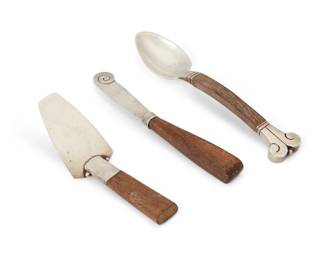 270
Mid-20th century
Three Mexican sterling silver table items
Three works:

William Spratling (1900-1967)
A sterling silver and carved wood petit four server
Circa 1964-1967, Third Design Period
Stamped for William Spratling; further stamped: [Eagle 30]
1.75" H x 4.5" W x 1.5" D
0.8 gross oz. troy approximately

Hector Aguilar (1905-1986)
A sterling silver and carved wood teaspoon
Marked: 940 / [conjoined 'HA' cipher] / Taxco / [Eagle 9]
6.5" L
1.4 gross oz. troy approximately

A Mexican sterling silver and carved wood butter spreader
Marked: JS [unknown maker] / 925 Sterling / [illegible]
5.5" L
0.7 gross oz. troy approximately

3 pieces
Estimate: $200 - $400