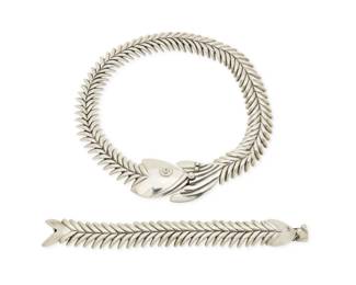 344
A set of D'Molina Mexican sterling silver fish jewelry
Late 20th century
Each stamped: D'Molina / Mex / 925 / TM-90
Comprising a chunky silver "fish scales" link necklace with fish motif clasp to front, together with a matching fish link bracelet, 2 pieces
Necklace: 18.25" L x 1.375" H; Bracelet: 7.5" L x 0.875" H
239.2 grams
Estimate: $500 - $700