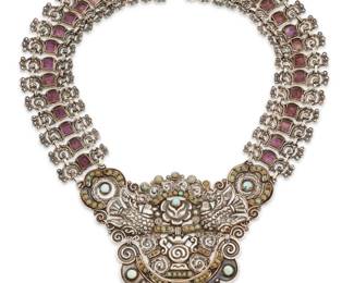 137
A Matl sterling silver and gem-set dove and basket necklace
Matilde Poulat (c. 1900-d. 1960)
Circa 1950-1960; Mexico City, Mexico
Etched in script verso: Matl / Mexico / 925 / Patente / 10466; further marked: [Eagle 129]
Designed by Matilde Poulat, an articulated sterling silver collar necklace with elaborate central plaque featuring doves and rose motifs with set turquoise and greenstone, suspended from multiple openwork scrolled links with pyramidal-cut set amethysts
19" L x 4.25" H
168.2 grams gross
Estimate: $4,000 - $6,000