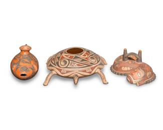 349
Three Latin American pottery effigy vessels
Three works:
Jorge Corona (b. 20th century)
A redware fish effigy vessel, 20th/early 21st century
Incised to underside: Jorge Corona
The fish-form vessel with black geometric motifs over a red slip glaze
4.375" H x 8.75" W x 3.75" D
Lourdes Villalba (b. 20th century)
A polychrome turtle effigy vessel, 20th/early 21st century
Incised to underside: Lourdes Villalba
The three-color turtle-form vessel with red and black geometric motifs on a tan slip glaze, featuring an animal figure to underside
3.375" H x 8.5" W x 10.5" D
A Peruvian Pre-Columbian-style whistling vessel, early 21st century
Unmarked
The polychrome reproduction of a Nazca zoomorphic whistle
3.625" H x 8.125" W x 4.875" D
3 pieces
Estimate: $200 - $400
