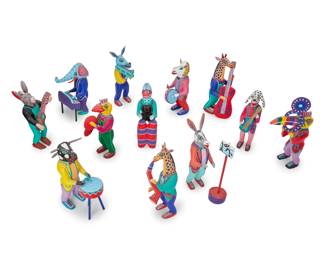 318
Late 20th/early 21st century; Oaxaca, Mexico
A group of Mexican alebrijes musician figures
Seven signed under foot: Martin Melchor; one signed and inscribed: Inocencio Vasquez M. / Sn Martin Tilcajete / Ocot. Oax.; half with applied sticker: Hecho en Mexico
The vibrantly painted folk art figures carved from copal wood, comprising various anthropomorphic animal figures playing various instruments and a conductor
12 pieces
Tallest: 8.75" H x 3.5" W x 2.5" D
Estimate: $400 - $600