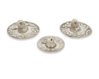 290
Three Mexican sterling silver sombrero ring holders
Early/mid-20th century; Mexico City, Mexico
Two marked: Sanborns / Mexico / Sterling; one marked: Plateria Alejo / Mexico / 925
Each ring dish in the form of a sombrero hat, two with repoussé silver floral motifs and eagle motif to crown, and one with chased silver motifs to brim
3 pieces
Largest: 1.5" H x 3.75" Dia.; Smallest: 1.5" H x 2.75" Dia.
3.715 oz. troy approximately
Estimate: $100 - $200