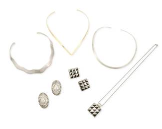 368
A group of Mexican silver and modernist-style jewelry
Late 20th century
Each marked for sterling; four variously marked for Mexico; round collar stamped: JS
Comprising a Mexican sterling silver and black enamel pendant necklace with geometric patterns, with a pair of matching clip earrings, together with a Mexican modernist-style sterling silver collar with shaped edges, and a pair of Mexican silver concho-style clip earrings, as well as two further collars, one a vermeil sterling silver V-shaped collar, and one round collar, 8 pieces
Necklace: 20" L x 1.25" H; Collars: 14.5" L & 11.5" L; Earrings: 1.625" H & 1.125" H
133.3 grams gross
Estimate: $200 - $400