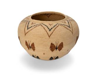 219
Late 20th/early 21st century; Sonora, Mexico
A Seri pictorial basketry vessel
The polychrome coiled basket depicting butterfly figures and a star motif to rim and base
12" H x 15.5" Dia.
Estimate: $200 - $400