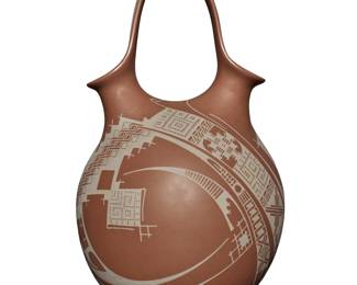 24
Damian E. Quezada (b. 20th century)
A Mata Ortiz pottery wedding jar, late 20th/early 21st century; Chihuahua, Mexico
Incised to underside: Damian E. Quezada
The jar with upper handle connecting opposed pour spouts, featuring matte white fine-line geometric motifs on a brown buff ground
12.75" H x 7" Dia.
Estimate: $500 - $700