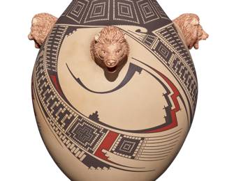 117
Noe Quezada (b. 20th century)
A Mata Ortiz polychrome pottery jar, late 20th/early 21st century; Chihuahua, Mexico
Incised signature to underside: Noe Quezada
The three-color jar with black and red geometric motifs to body on a white slip, featuring three applied bear heads with incised details
13.5" H x 12.5" Dia.
Estimate: $400 - $600