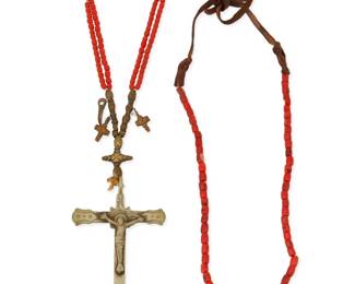 342
A Spanish Colonial devotional necklace and strand of beads
Late 19th century and later
A Spanish Colonial devotional rosary necklace with stamped metal cross pendant and brass-toned charms and beads, with sections of double strand red glass beads, as well as a single strand of coral beads with a leather neck cord, 2 pieces
Larger: 42" L x 6" H; Smaller: 25" L
212.9 grams gross
Estimate: $300 - $500