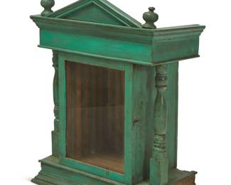 252
Early 20th century
A Guatemalan nicho cabinet
The painted wood display cabinet of mortise and tenon construction, with glazed hinged door centering architectural molding and opposed turned wood columns, surmounted by a cross centering two turned finials
31.75" H x 21.75" W x 11.375" D
Estimate: $400 - $600