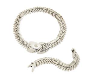 343
A set of D'Molina Mexican sterling silver fish jewelry
Late 20th century
Each stamped: D'Molina / Mex / 925 / TM-90
Comprising a chunky silver "fish scales" link necklace with fish motif clasp to front, together with a matching fish link bracelet, 2 pieces
Necklace: 18" L x 1.5" H; Bracelet: 7" L x 1" H
254.8 grams
Estimate: $600 - $800