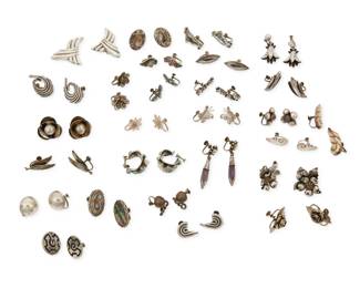 371
A large group of Mexican silver earrings
Mid/late 20th century
Variously marked for maker, for silver and for Mexico; further variously marked: [Design number} / [Eagle 16] / [Eagle 3] / [Eagle 23]
Comprising twenty-seven pairs of earrings by various makers including Hector Aguilar, Margot de Taxco, Felipe Martinez/Piedra Y Plata, and Coro, in various designs such as floriform, abstract, botanical, and figural, five with mother-of-pearl shell inlay, three with set stones including amethyst, two pairs with enamel accents, and three pairs in fine silver filigree, 54 pieces approximately
Largest: 2.125" H x 1.375" W; Smallest: 0.75" H
225.3 grams gross
Estimate: $200 - $400