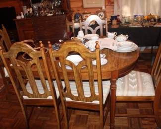 Table has extension, 6 chairs and custome embroidery table cover. 