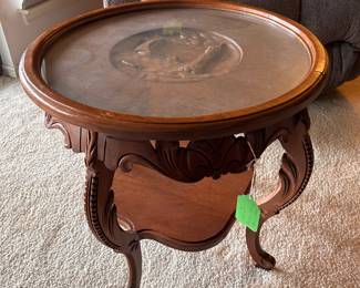 small round table with carved center and glass top