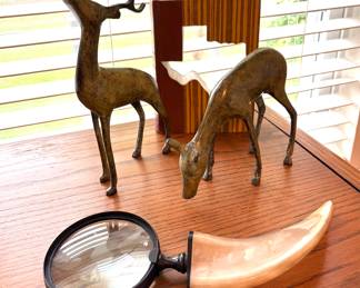 Metal deer and magnifying glass on horn