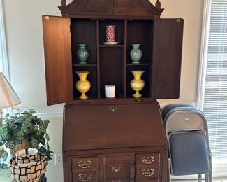 Fold down desk with decorative shelves.