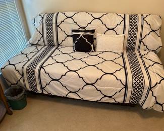 Day bed with decorative cover.