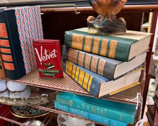 old books, statues, old tobacco metal can 