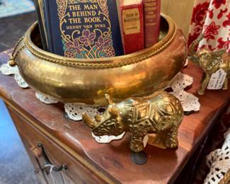 brass statuary, old books, rhinoceros, end tables