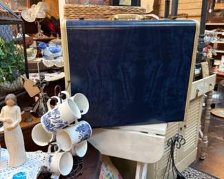 Vintage suitcase, unique coffee mugs, willow tree, vintage dressers, end tables. 