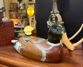 Vintage decoy duck, old lighted globe, barrister bookcase