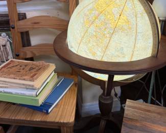 Lighted vintage globe, old books, chairs, art. 