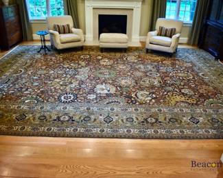Handknotted Tabriz style rug in shades of brown, beige, red and green. Measures approx. 14' x 19'