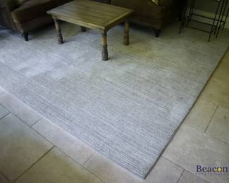 Beige area rug. Measures approx. 9'5" x 11'
