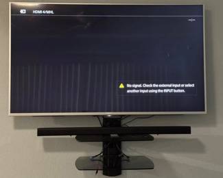 Sony 55 TV and Samsung soundbar and speaker, with floating shelf TV wall mount