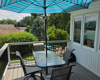 Outdoor glass top patio set with 4 chairs and umbrella. Very good Condition!