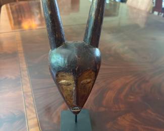 Kwele Mask - type of African art originating from the Kwele people of Gabon. The mask holds deep spiritual meaning and are used in Bwete rituals to promote protection, harmony , and connection to the spirit world.