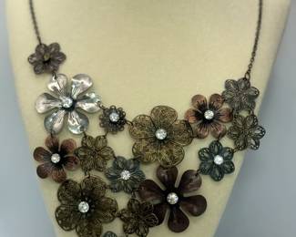 Vintage Metal Necklace with Various Metal Flowers and Rhinestones. Total hanging length is 11".
USA Shipping Only.