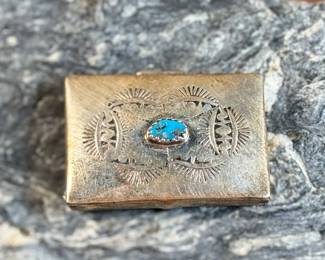 This lot features a vintage Native American pill box, made of sterling silver with a Turquoise center stone. Marked sterling with a total approx. weight of 8.55 grams and measures 1.5” W x 1” D.
