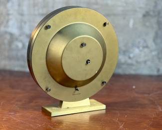 This lot features a Kundo Kieninger & Obergfell world clock, made in West Germany circa 1960s. This clock features quartz movement, elegant gold and white clock face, and a sleek brass case. The clock is designed to allow one to quickly calculate the time in any area of the world. In good working condition and measures, 10” H x 9” W x 4” D.
