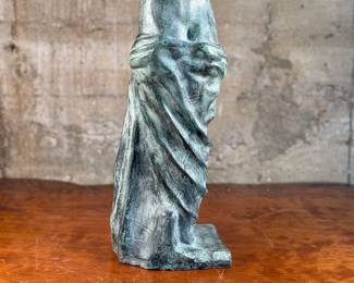 This lot features a famous replica of the Venus de Milo, one of the most famous ancient Greek sculptures. Made in Spain with maker mark near bottom as shown in photos. This sculpture is believed to be made of a hollowed bronze and measures, 24” H x 7.5” W x 7.5” D. The Venus de Milo is a masterpiece of Hellenistic sculpture and is renowned for its idealized beauty and enigmatic appeal, partly due to its missing arms.

