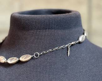 This lot features a beautiful sterling silver necklace with pendant by designer, Avi Soffer. Marked as shown in photos and measures, 18” with a total approx. weight of 48.00 grams. Avi Soffer is an Israeli jewelry designer known for his international perspective and commitment to social impact. He apprenticed with jewelry makers in Israel and Denmark, developing a unique design aesthetic. Soffer is actively involved in supporting human rights causes, including empowerment programs for Arab women in Israel and volunteering at a refugee center. He also mentors new artisans and employs individuals with disabilities in his workshop.
