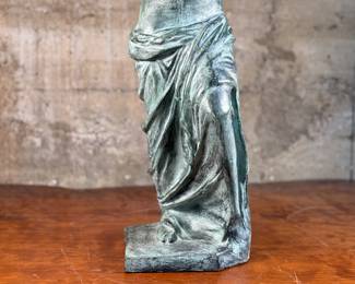 This lot features a famous replica of the Venus de Milo, one of the most famous ancient Greek sculptures. Made in Spain with maker mark near bottom as shown in photos. This sculpture is believed to be made of a hollowed bronze and measures, 24” H x 7.5” W x 7.5” D. The Venus de Milo is a masterpiece of Hellenistic sculpture and is renowned for its idealized beauty and enigmatic appeal, partly due to its missing arms.
