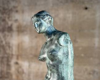 This lot features a famous replica of the Venus de Milo, one of the most famous ancient Greek sculptures. Made in Spain with maker mark near bottom as shown in photos. This sculpture is believed to be made of a hollowed bronze and measures, 24” H x 7.5” W x 7.5” D. The Venus de Milo is a masterpiece of Hellenistic sculpture and is renowned for its idealized beauty and enigmatic appeal, partly due to its missing arms.

