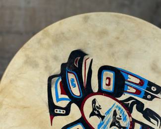 “Tlingit Eagle”, artwork on a drum by listed artist Jerry Lieb, Jr., otherwise known as Sivaluaq circa 2006. This work comes with a mounted handle and measures, 21.75” H x 15” W. Artist and artwork information on the verso as shown in photos.
