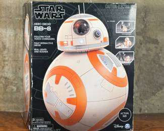 This lot features a new in box, Star Wars Hero Droid BB-8 fully interactive droid. Hero Droid BB-8 comes to life with an impressive height of over 16 inches (19 inches with antenna), voice and sound responses, and a motion sensor. Enjoy full control of your BB-8 with multiple voice commands, 360-degree remote control movement, and unique Follow Me mode which allows Hero Droid BB-8 to roll along beside you just like in the film!
