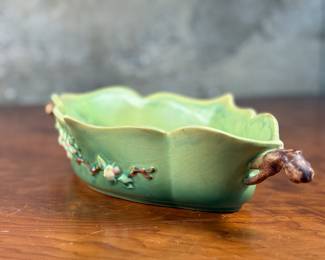 This lot features a Roseville Apple Blossom double handle vase in good overall condition with maker mark present underneath as shown in photos. This vase measures, 3” H x 15.5” W x 8” D.

