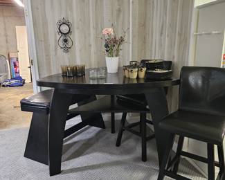 $495 Pre Sale Item - See Sale Description for purchase details. Bar Height Dining Table Set, Color Black. Triangular Table, seats 4 . Includes table, 2 leather chairs and leather bench, Seating: 32"H. Table 54"L x 54"W x 41"H. Pic 1 of 4