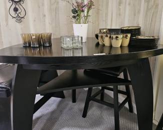 $495 Pre Sale Item - See Sale Description for purchase details. Bar Height Dining Table Set, Color Black. Triangular Table, seats 4 . Includes table, 2 leather chairs and leather bench, Seating: 32"H. Table 54"L x 54"W x 41"H. Pic 2 of 4
