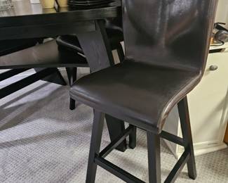 $495 Pre Sale Item - See Sale Description for purchase details. Bar Height Dining Table Set, Color Black. Triangular Table, seats 4 . Includes table, 2 leather chairs and leather bench, Seating: 32"H. Table 54"L x 54"W x 41"H. Pic 3 of 4