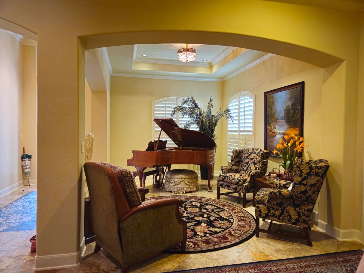 Baldwin baby grand piano in background.