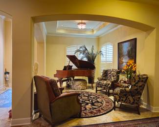 Baldwin baby grand piano in background.